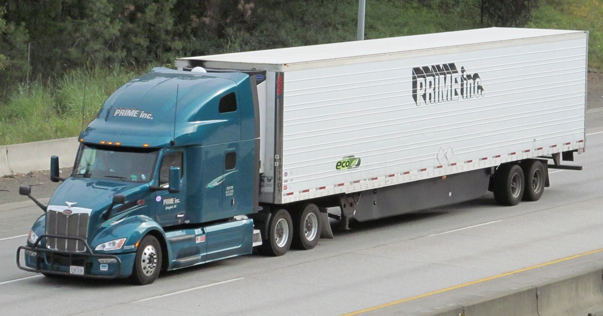 A Peterbilt semi-truck with refrigerated trailer running on Interstate 90